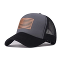 Detail of grey mesh trucker hat featuring a faux leather US flag patch on the front - Black and Gray