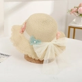 Detailed close-up of straw sun hat featuring lace wave edge and large mesh bow decoration - Beige Hat