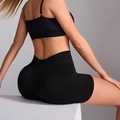 Women's high-waisted seamless scrunch butt yoga shorts in solid black ribbed fabric - S / Black