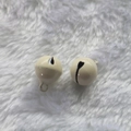 Pair of 14mm beige painted metal bells for pet collars and DIY keychains on plush background - Off White