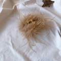 Detailed view of the large ostrich feather claw clip with soft beige fluff and gold spring - 9.5CM Light Brown Feather Claw Clip
