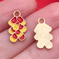 DIY jewelry charm with red and yellow enamel fish scale design and golden metal backing - Firecrackers