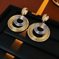Pendientes de aro entrelazados en oro y plata con botón ovalado sobre cuero negro - Bicolor Oro y Plata