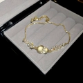 Elegant gold bracelet with cat eye stone and cubic zirconia in a jewelry box - Gold
