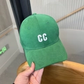 Detailed view of the grass green baseball cap with white CC embroidery and cotton texture - Green