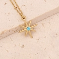 Detail of a gold sunburst pendant with a blue gemstone on a beige stone surface - Blue Gemstone Eight-Pointed Star Style (8#)