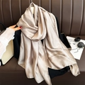 Champagne satin silk scarf draped elegantly showing smooth glossy texture and soft drape - Light Khaki