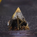 Orgone pyramid with black obsidian stones and golden runic symbol on a dark surface - Thor - Protection From Ill-wishers