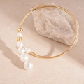 Macro-opname van gouden choker met witte parels op een getextureerde stenen ondergrond - Gouden parel choker
