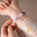 Elegant beaded bracelet with purple cat-eye stones and silver hollow floral spacers - Purple and White