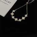 Elegant gold multi-clover bracelet with adjustable sliding clasp and cream white accents - Petal Style Bracelet