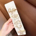 Detail of 5-piece gold hair clip set with pearls and rhinestones on a white card - Retro Starfish Hair Clip 5-Piece Set