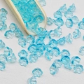 Macro shot of light blue lily of the valley glass beads spilling from a wooden spoon - Lily of the Valley 35# Transparent Blue 7x12mm