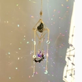 Detail of golden sun catcher with black raw stone and crystal prisms for rainbow reflection - 49-51cm / Gold Alloy + Obsidian