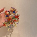 Detailed view of colorful handmade beaded floral drop earrings held in hand for summer - Resort Style Beaded Style (16) / Regular / Colorful