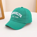 Close-up of white Brooklyn New York 3D embroidery on green cotton baseball cap - 54cm (3-8 Years) / Green
