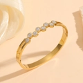 Detailed view of gold plated titanium steel bangle with hollow design and sparkling crystals - Gold Round Full Diamond Style (M712)