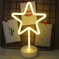 Star shaped neon LED desk lamp with warm yellow light on a white round base - Warm White Star