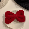 Red velvet bow hair clip for girls displayed in a white decorative shell dish - Red Velvet Bow / Red