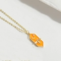 Golden hexagon enamel pendant necklace featuring a bee, moon, and stars motif - Orange