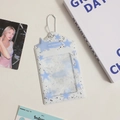 Detail of PVC star print photocard holder with silver chain and ink splash pattern - Blue