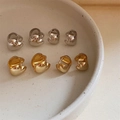 Polished heart-shaped hoop earrings in gold and silver finishes on a ceramic tray - EH0394/Silver Small Heart Hoop