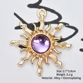 Detail showing a 2.7x3.0cm gold alloy sun charm with a central purple gemstone - Amethyst
