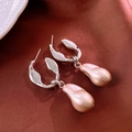 Silver needle earrings with pink pearl drop charms on a dark red silk background - Silver Pink Pearl Pendant
