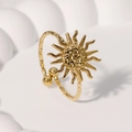 Polished gold sunburst ring with hammered texture and adjustable open band on white podium - Gold
