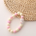 Pink and beige beaded phone strap with a white cartoon bear charm and heart bead - Backpack Bear (K559)