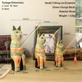 Set of three Nordic wooden cat figurines with fishing rods in green orange and black - Cat Fishing Set (036) / Green Orange Black
