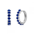 Silver hoop earrings featuring prong-set round blue cubic zirconia in a minimalist style - Silver with Blue Pave Huggie
