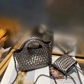 Silver woven bucket bag set with top handle and metal chain strap on wooden table - Antique Silver