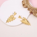 Detail of vintage gold double heart drop earrings on a white platform with pink background - Gold