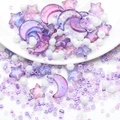 Detailed macro view of purple gold-foil moon and star acrylic beads with white seed beads - Blue Purple Gold Flecked Series