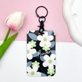 Floral ID card holder with black base and white flower pattern on a pink wristlet strap - Black Handcuff Buckle / White Green