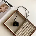 Mini black leather pouch with gold snap button and long lanyard on a wood tray - 6# Necklace-Black