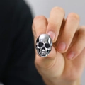 Close-up of vintage skull ring in polished stainless steel with retro blackened details - US 10 / Steel