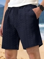 Detail of dark blue casual shorts featuring textured jacquard fabric and drawstring waist - S / Navy Blue
