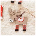 Close-up of wooden reindeer Christmas ornament with red stripes and checkered bow detail - Gray