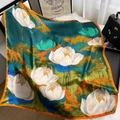 Elegant 90cm silk-like scarf with green lotus print and orange borders laid flat - Style 12