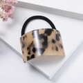 Close-up of tortoise shell pattern acetate geometric hair tie on a white pedestal - Light Coffee