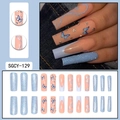Long coffin nails with blue butterfly, glitter, and rhinestones on denim background - Nude Light Blue Butterfly Glitter Rhinestone Style (SGCY-129)