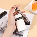 White woven coin purse with silk scarf detail and golden keyring holder for women - White