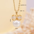 Elegante collana a fiocco dorato con grande pendente di perla tonda e zirconia cubica - Oro