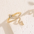 Adjustable gold snake ring featuring shimmering zircons and vibrant emerald green eyes - 14K Gold White Zirconia Snake