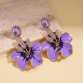 Dettaglio orecchino a fiore in smalto viola con strass su pietra naturale - Viola