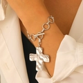 Silver snail swirl textured cross bracelet with OT toggle clasp on model wrist - Silver Bracelet (Wrinkled Cross 7124)