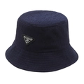 Navy blue bucket hat with textured fabric and a metal triangle fashion badge on front - Blue