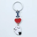 Close-up of metallic keychain featuring blue letter I, red heart and dog charms - Black and White Dog Style (17)